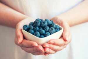 Woman offering blueberries